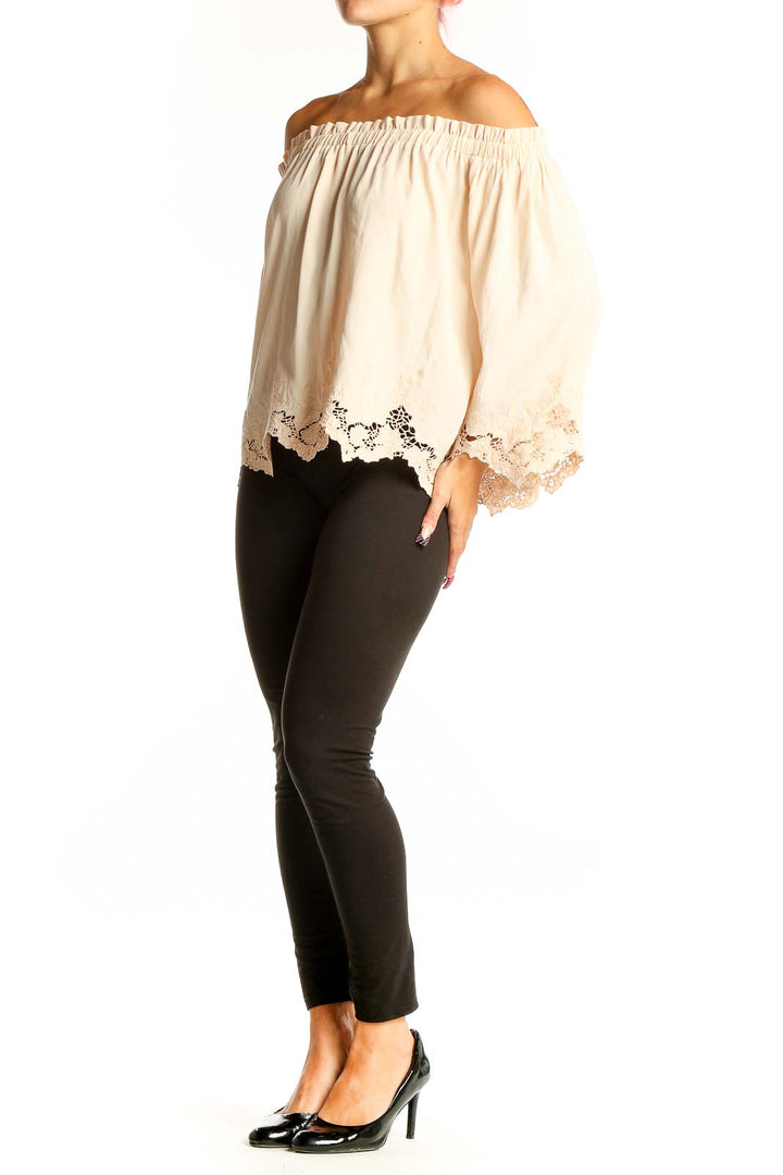 Front view of cream off-shoulder lace-trimmed blouse by ASTR