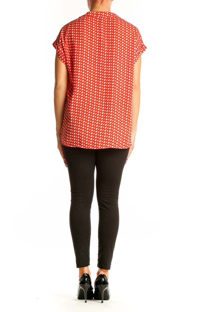 Side view of Pleione red polka dot short sleeve blouse on model