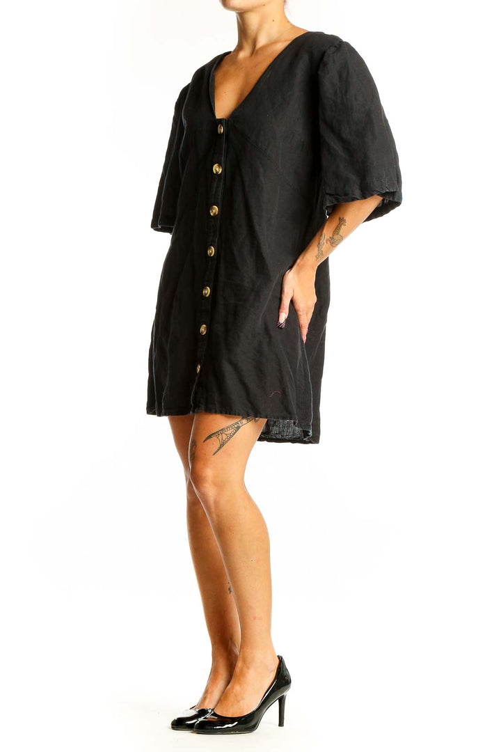 Front view of black Topshop mini dress with gold buttons and flutter sleeves