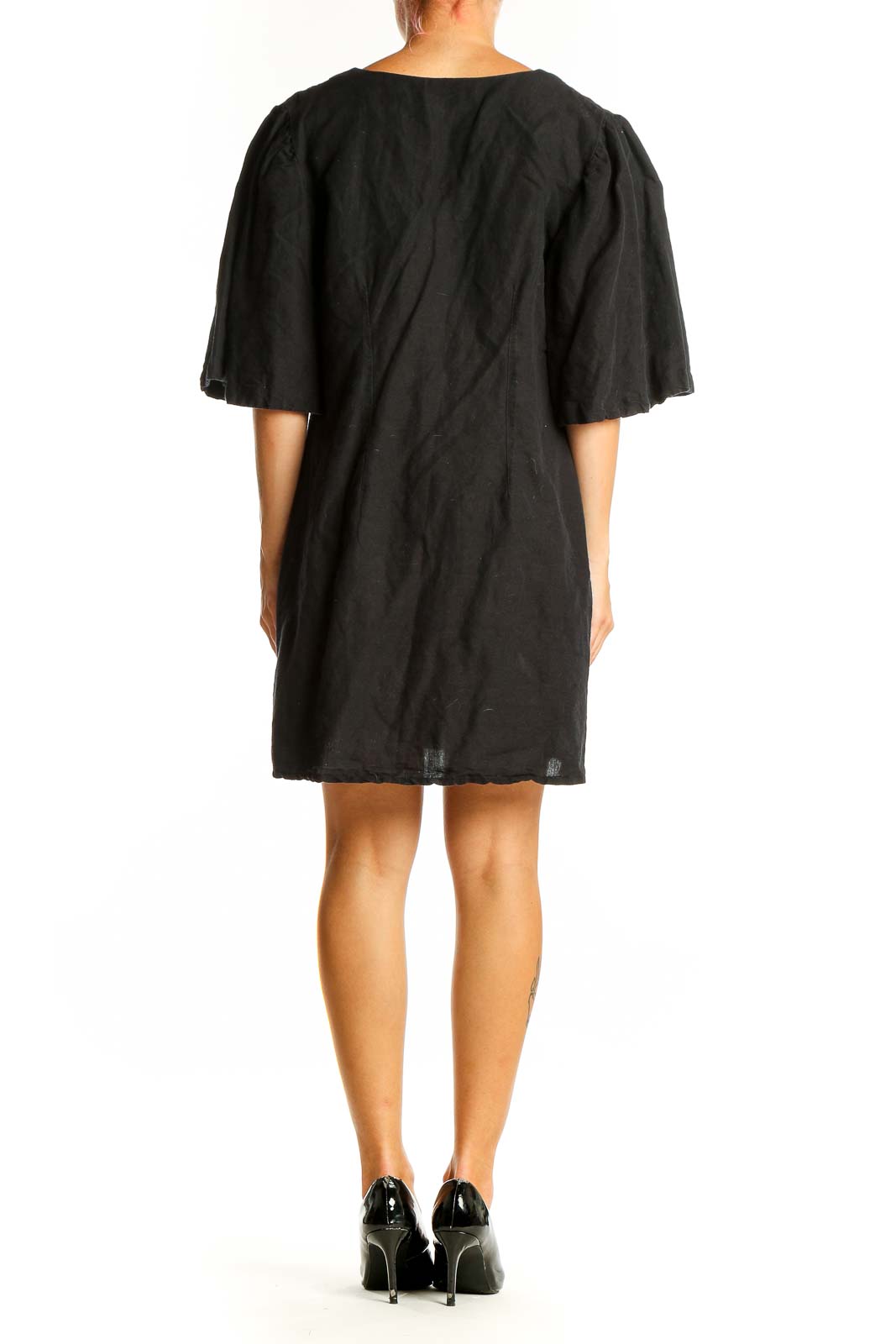 Side view of black Topshop mini dress showing flutter sleeves and length