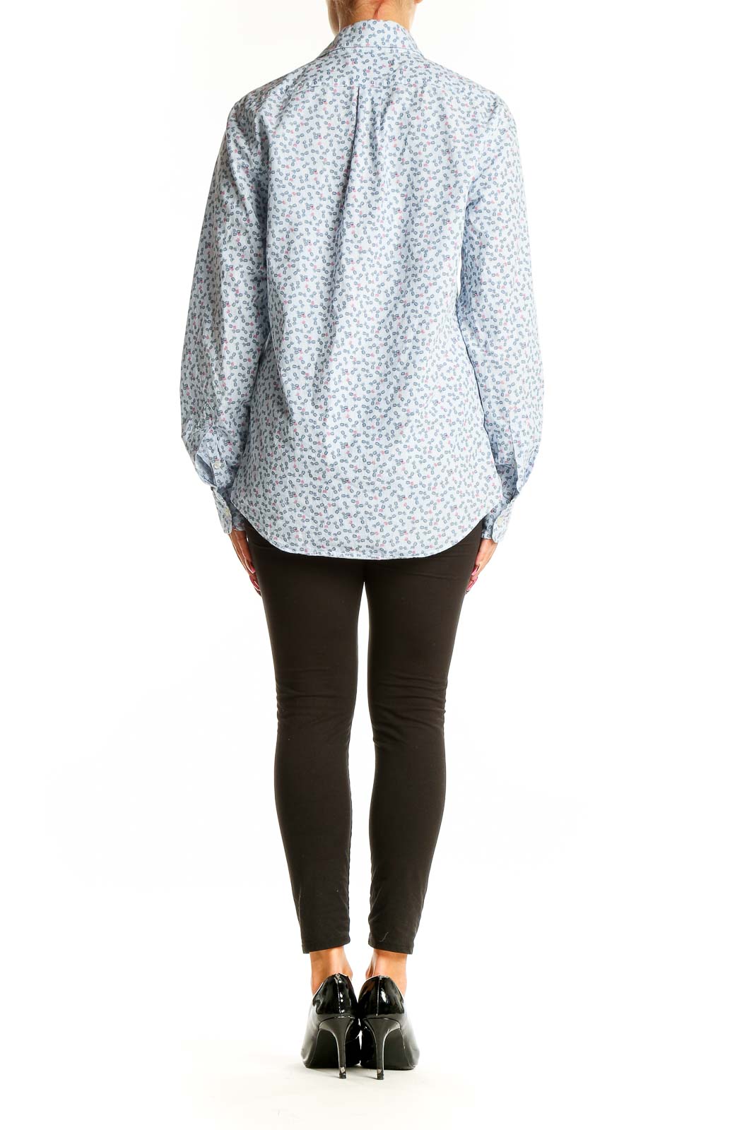 Side view of model wearing vineyard vines light blue floral print cotton shirt with black pants