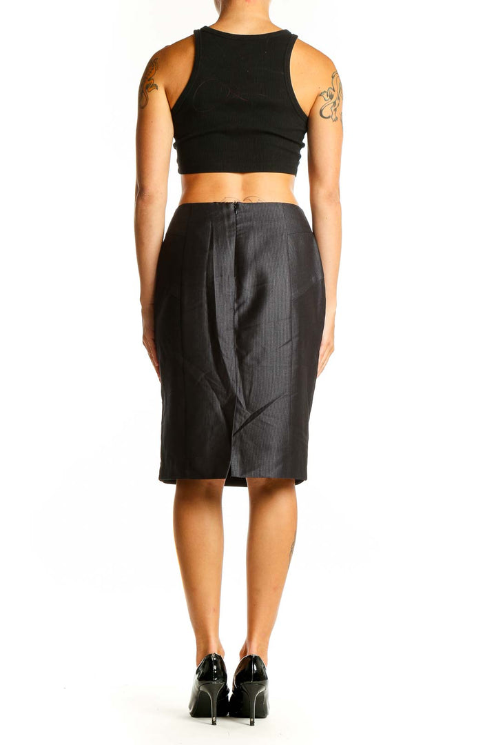 Side view of woman wearing Koton black pinstriped pencil skirt with black top