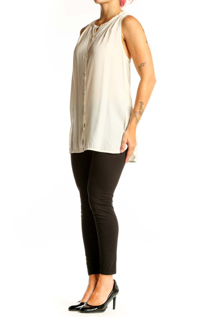 Front view of cream sleeveless button-down blouse from Banana Republic