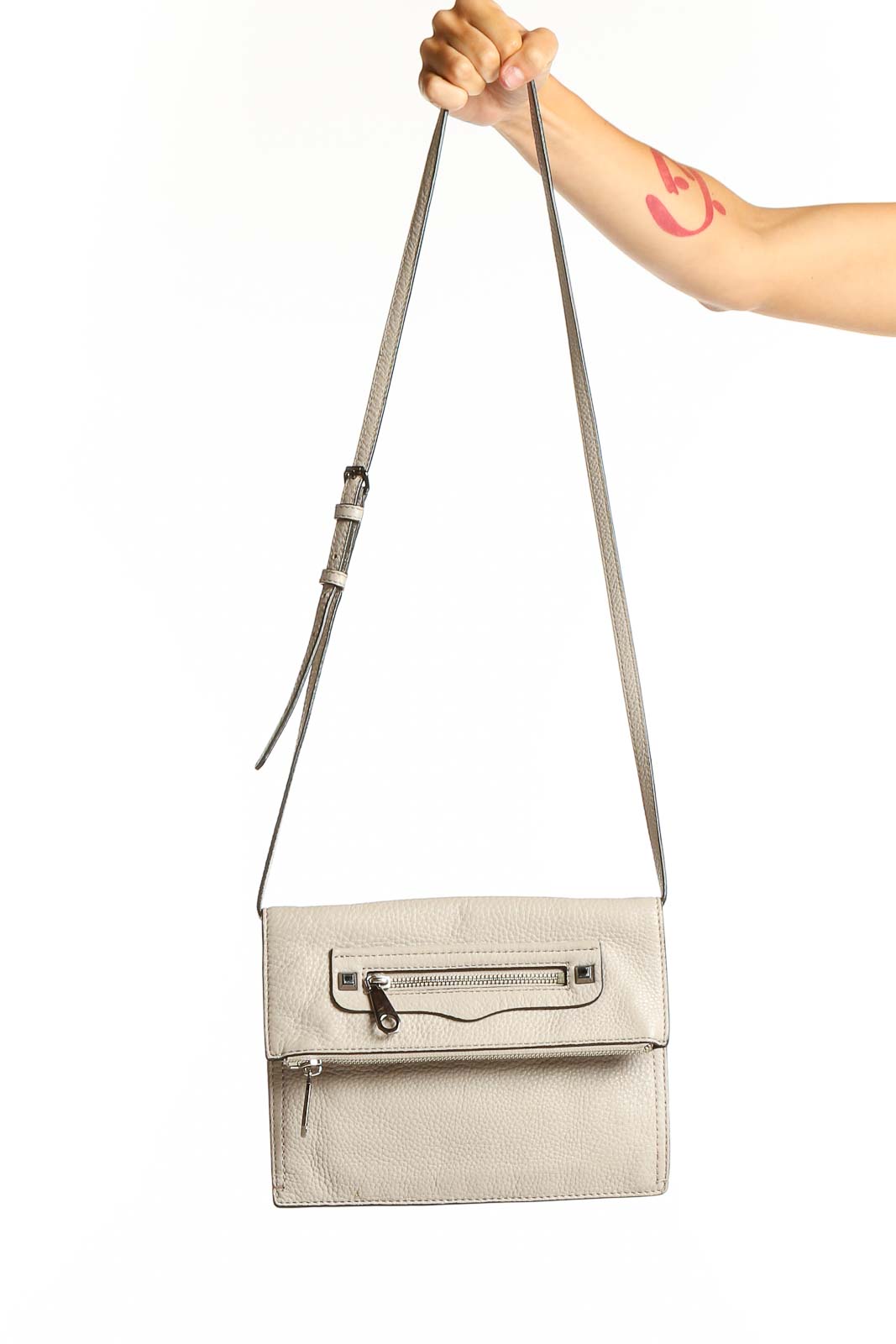 Front view of Rebecca Minkoff beige leather crossbody bag with silver hardware