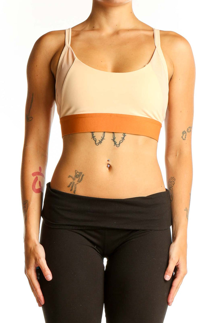 Front view of Adidas beige and orange sports bra