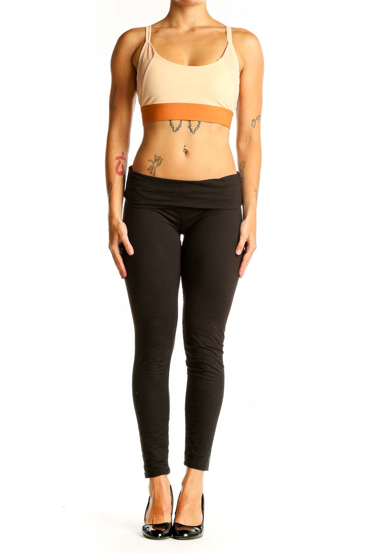 Front view of Adidas beige and orange sports bra