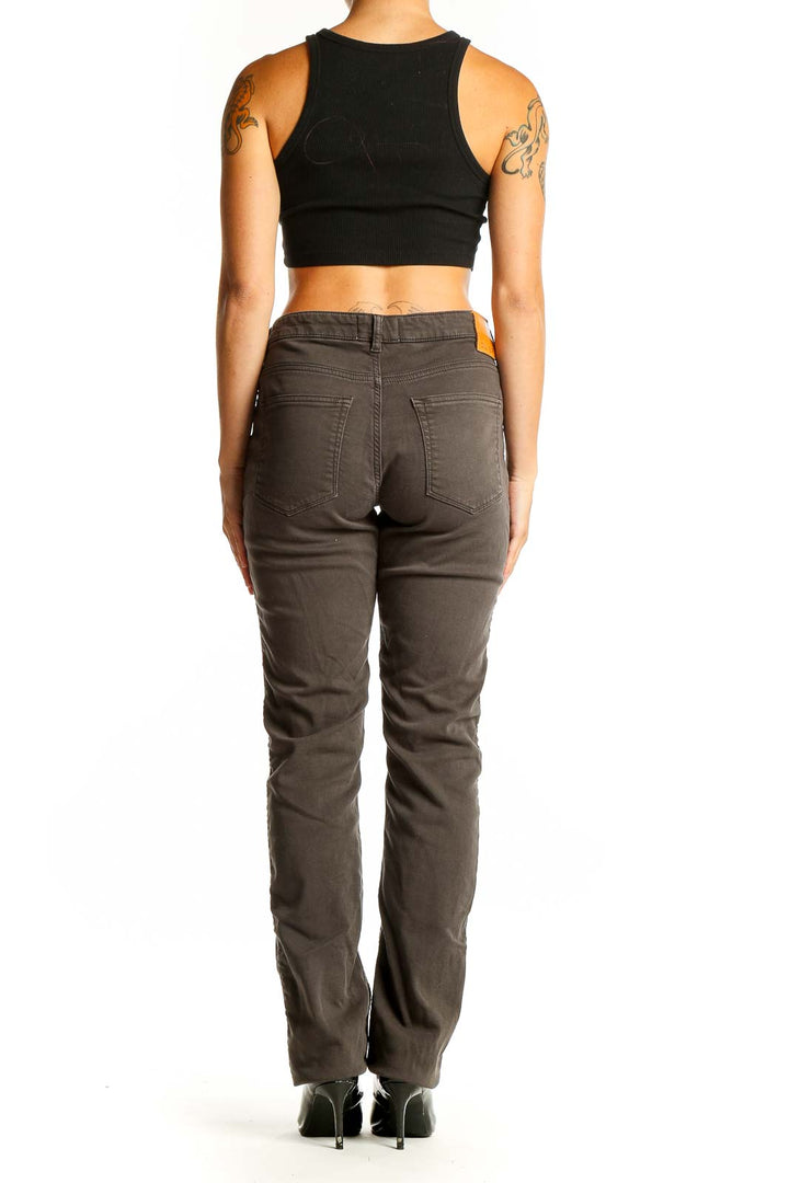 Side view of DU/ER brown straight leg jeans on woman with black top