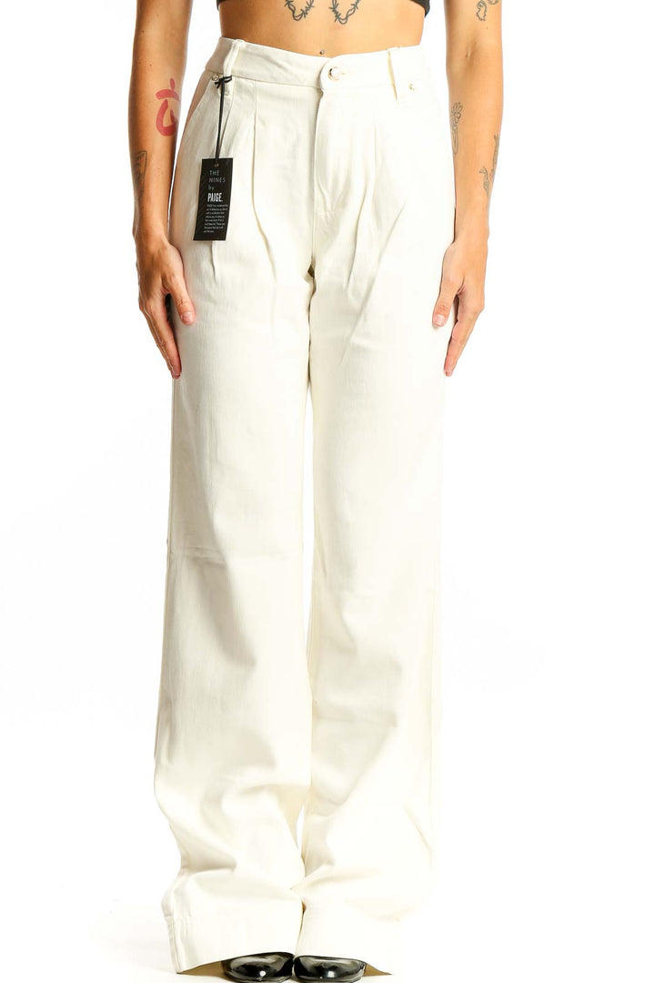 Front view of Paige white wide-leg trousers with pleated design