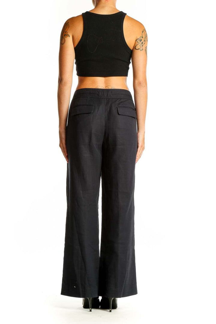 Side view of Ann Taylor black wide-leg acetate pants on model