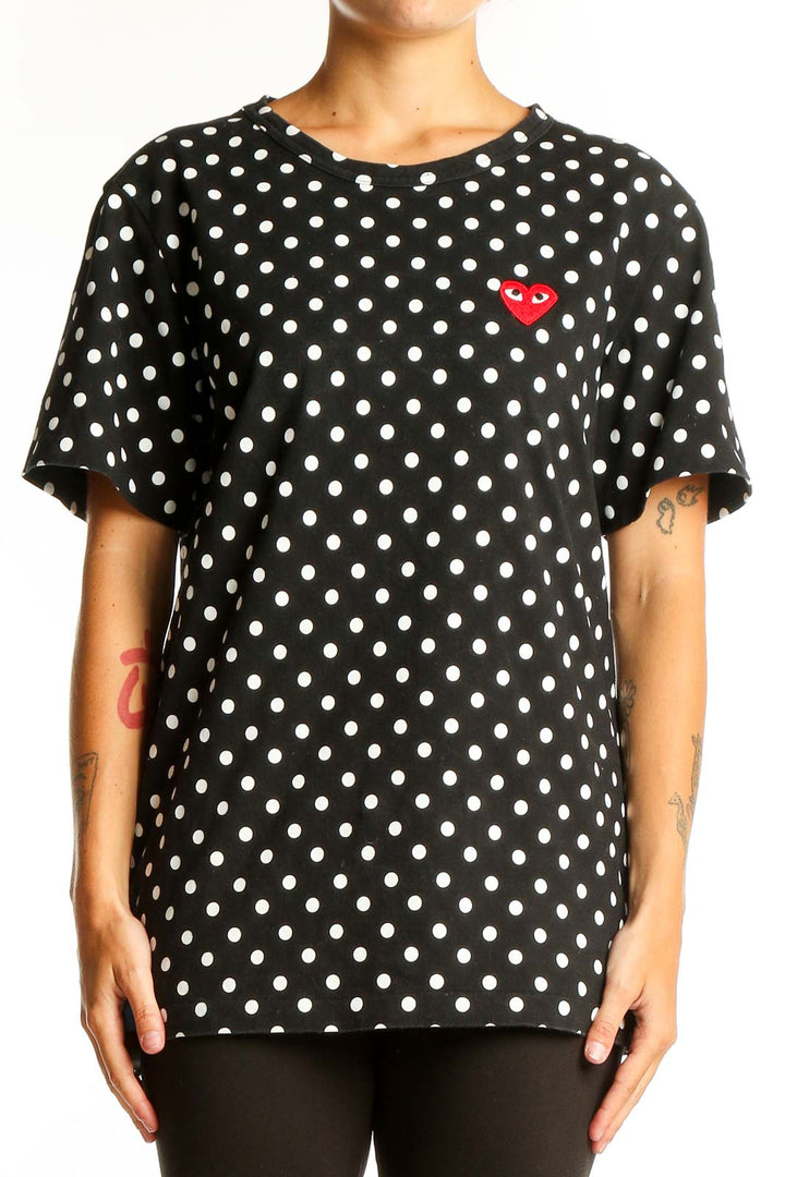 Front view of PLAY Comme Des Garçons black polka dot t-shirt with red heart logo