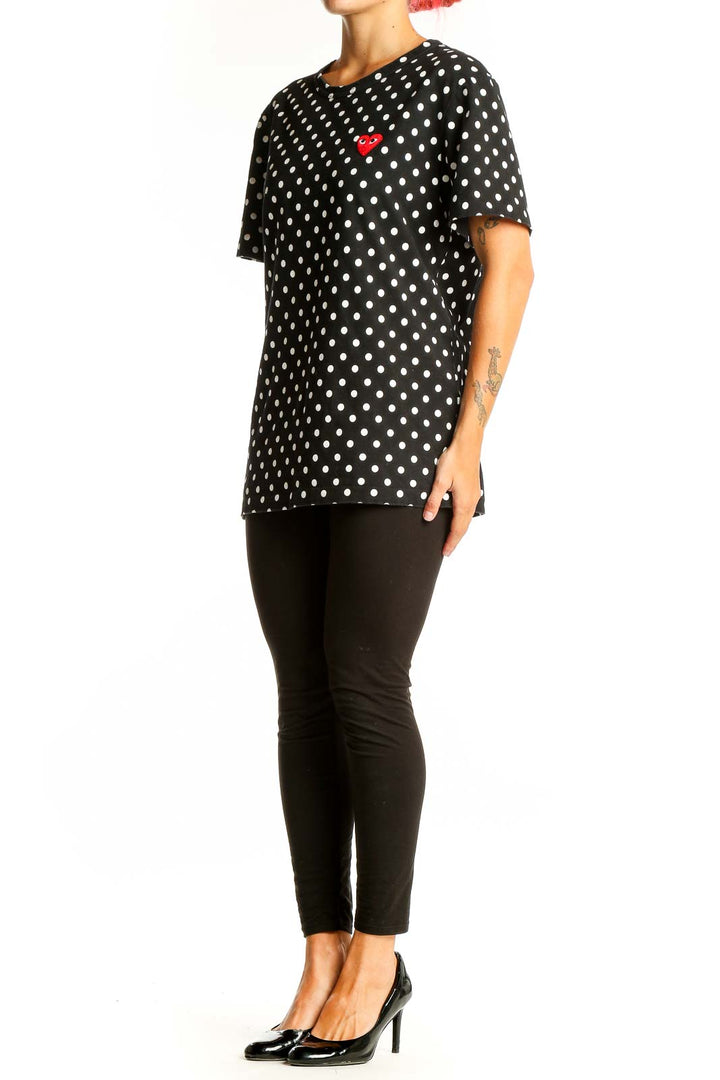 Front view of PLAY Comme Des Garçons black polka dot t-shirt with red heart logo
