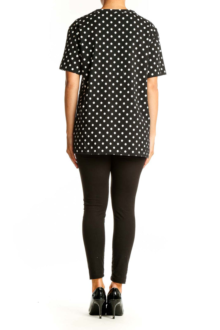Back view of PLAY Comme Des Garçons black polka dot t-shirt on model