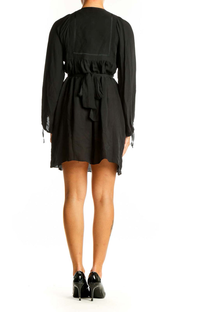 Side view of black Betsey Johnson dress showing flowing silhouette