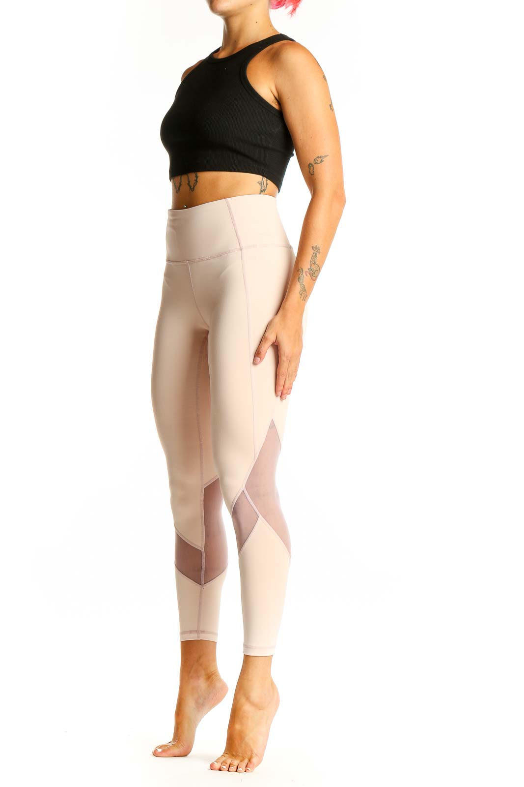 Front view of beige Athleta high-waisted leggings with mesh panels