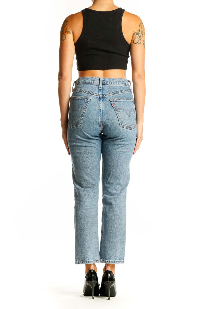 Back view of Levi's light blue straight leg jeans on model