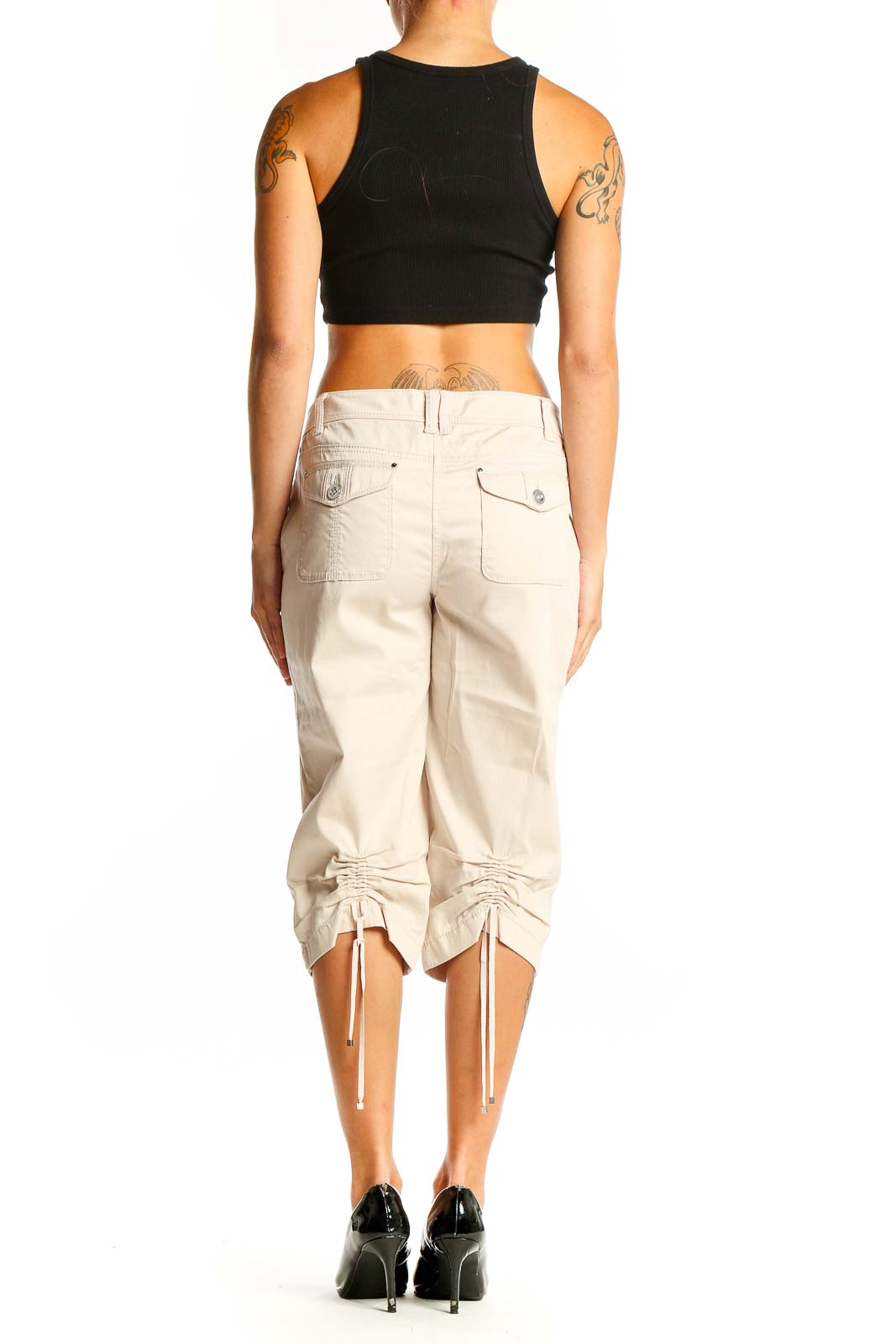 Side view of model wearing White House Black Market beige capri pants with black top
