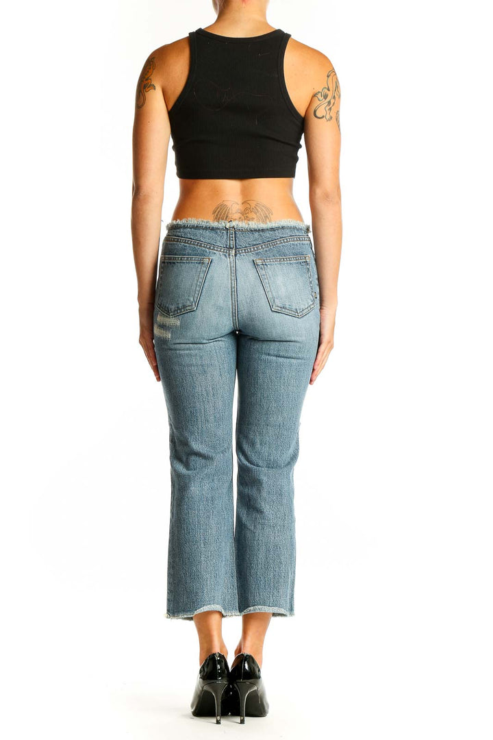Side view of model wearing California Dream light blue distressed cropped jeans