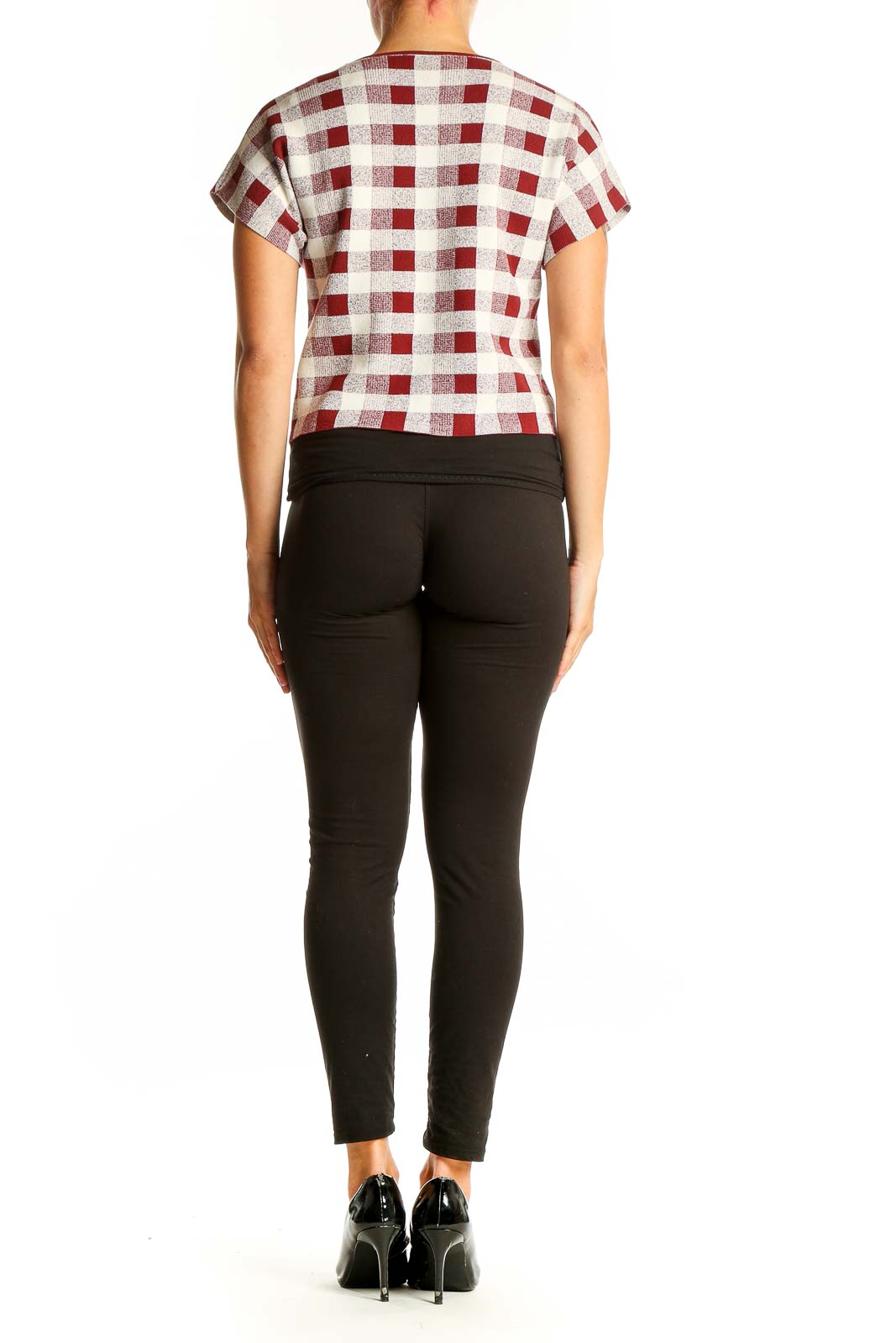 Side view of model wearing SilkRoll red and white checkered crop top with black pants