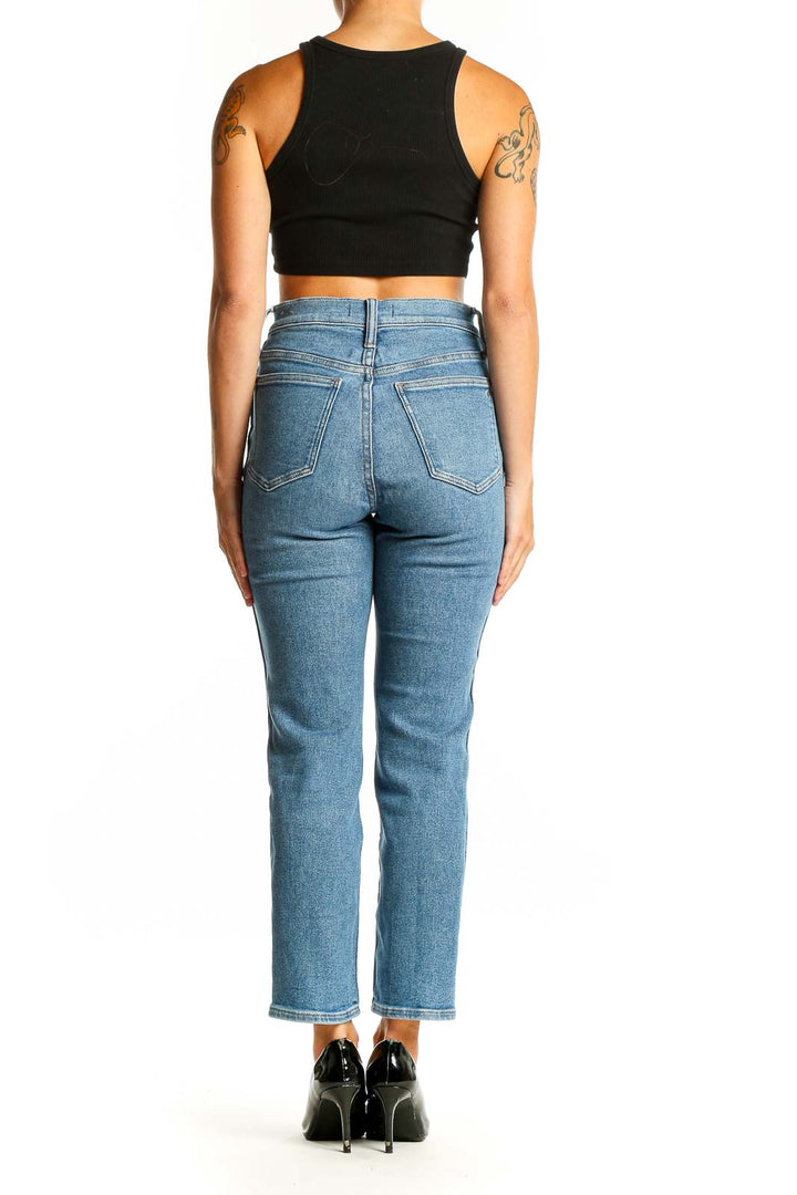 Back view of Madewell light blue high-waisted straight leg jeans on model