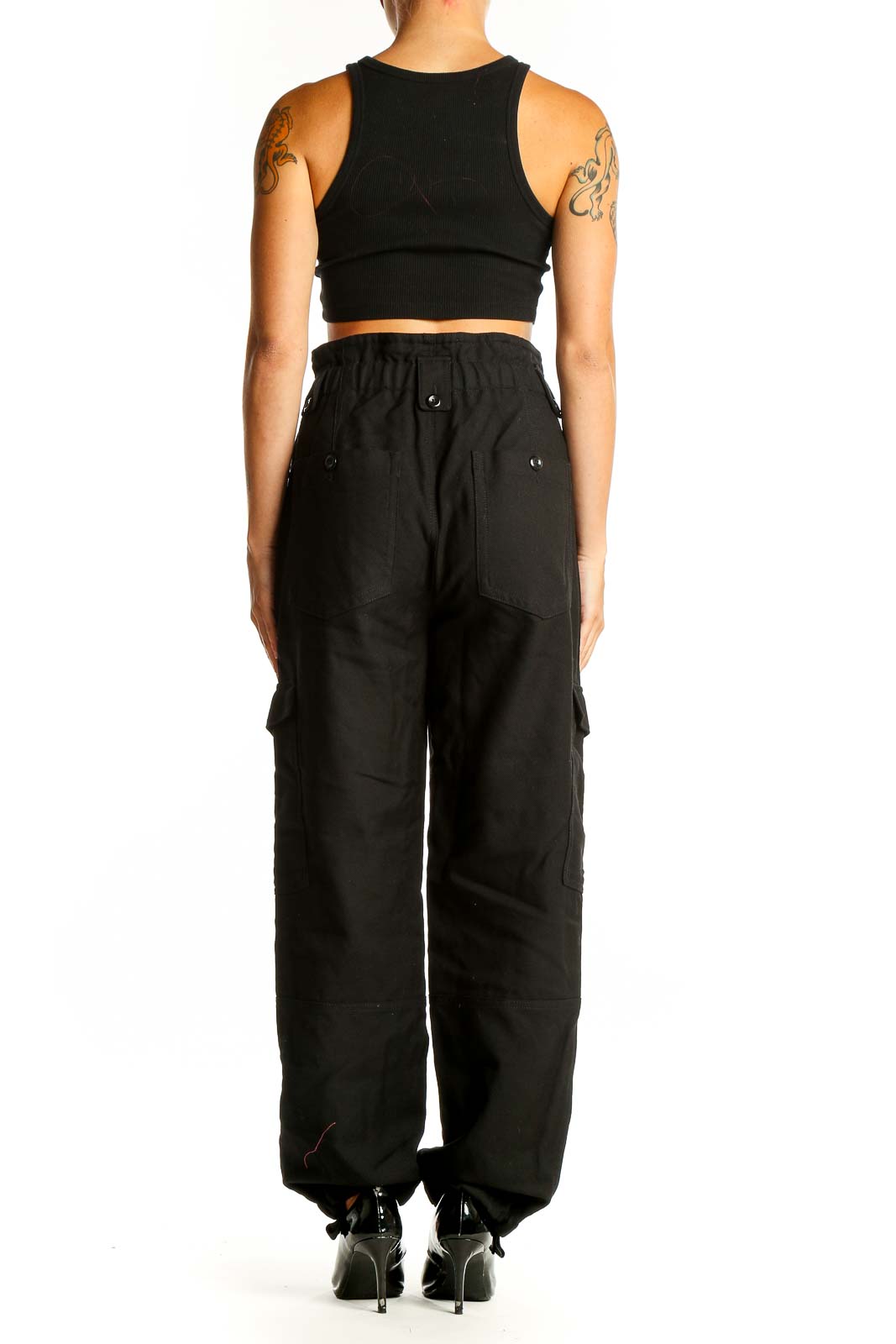 Side view of woman wearing Banana Republic black wool cargo pants with crop top