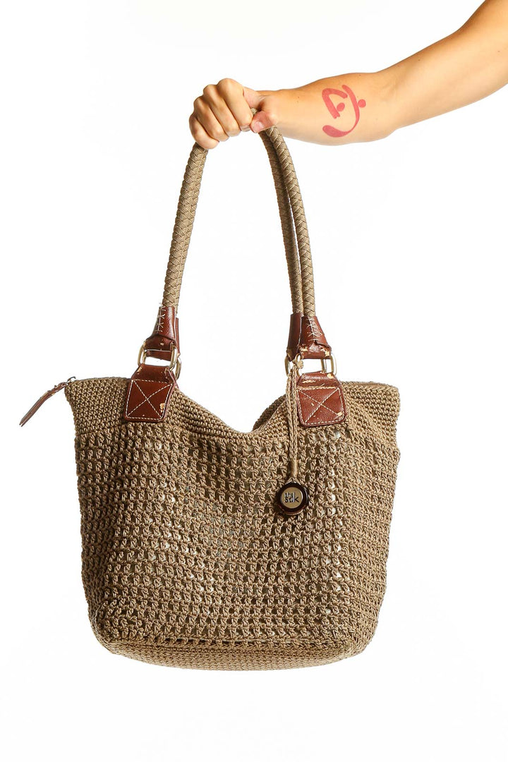 Front view of The Sak tan woven polypropylene shoulder bag with leather handles
