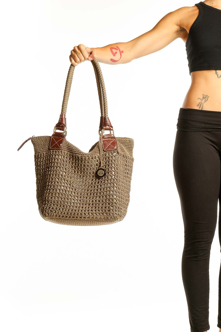 Front view of The Sak tan woven polypropylene shoulder bag with leather handles