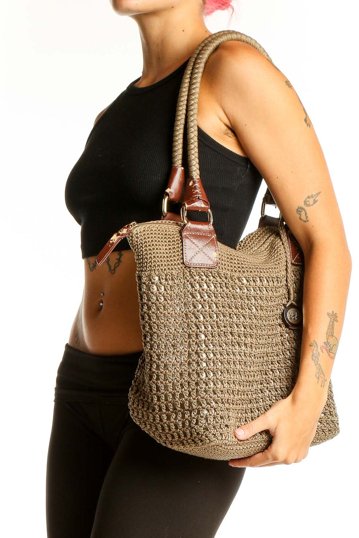 Front view of The Sak tan woven polypropylene shoulder bag with leather handles