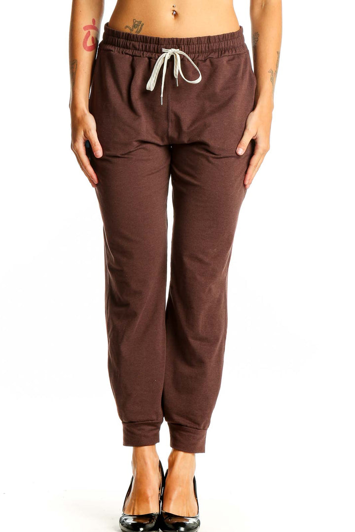Front view of brown Vuori jogger pants with drawstring waist