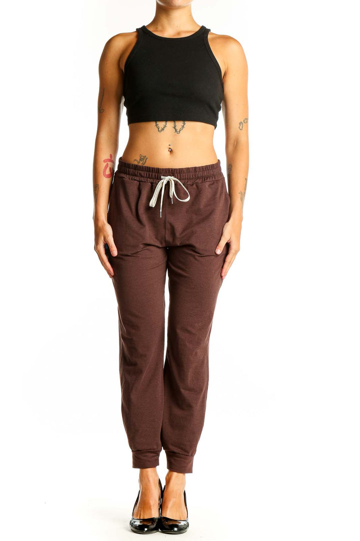 Front view of brown Vuori jogger pants with drawstring waist