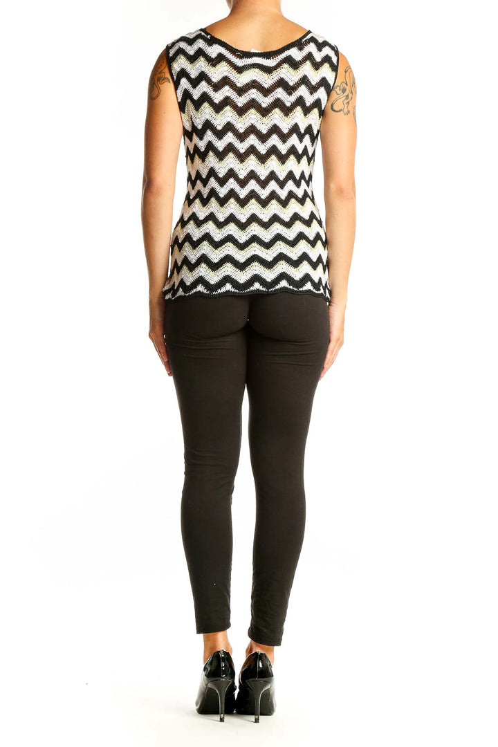 Side view of model wearing Missoni black and white chevron knit tank top with black pants
