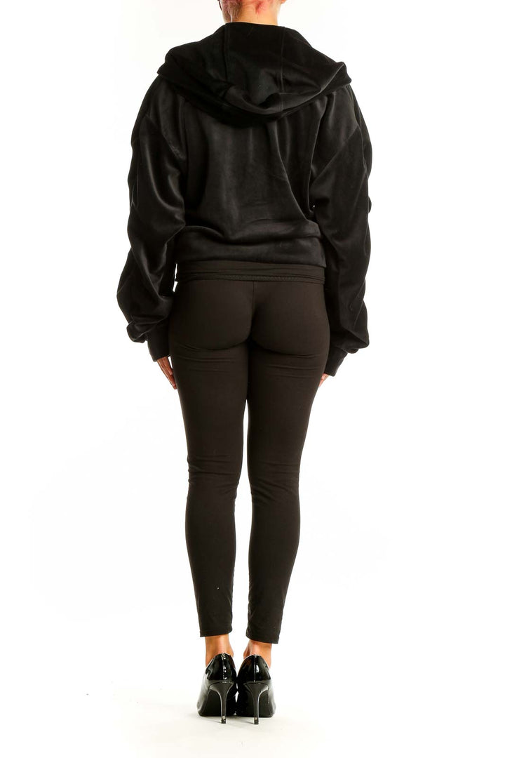 Back view of Juicy Couture black velour zip-up hoodie jacket on model