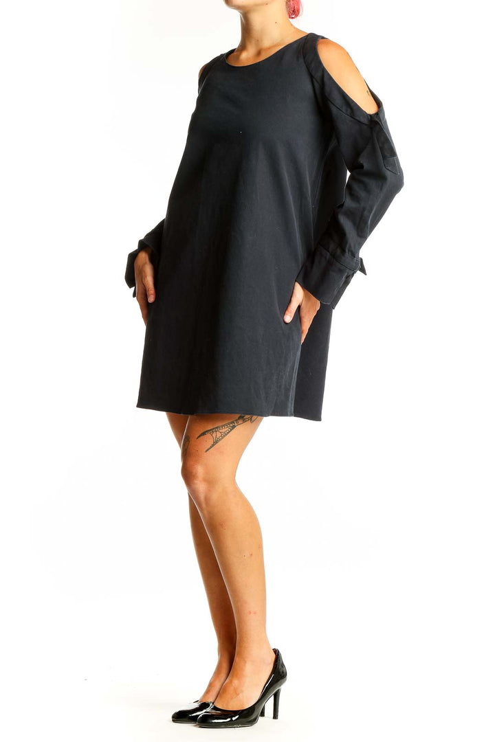 Front view of black Zara Trafaluc mini dress with cold shoulders and tie-sleeves