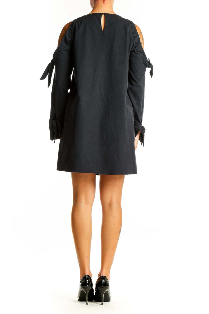 Side view of black Zara Trafaluc mini dress showing cold shoulder detail