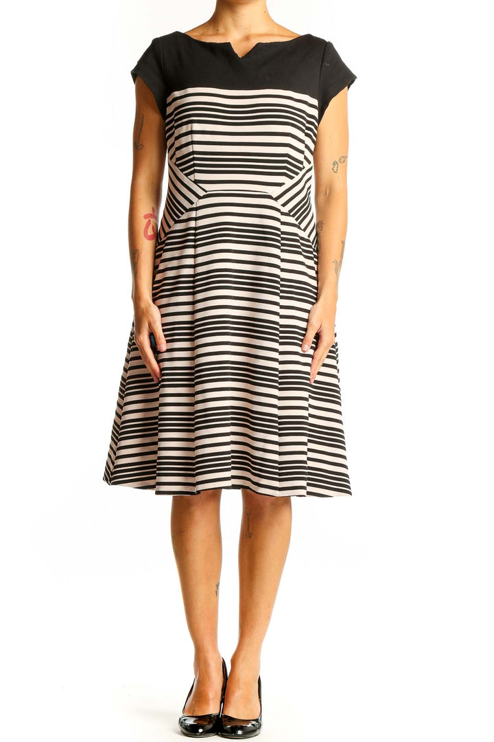 Front view of Nanette Lepore black and white striped fit-and-flare dress with boat neckline
