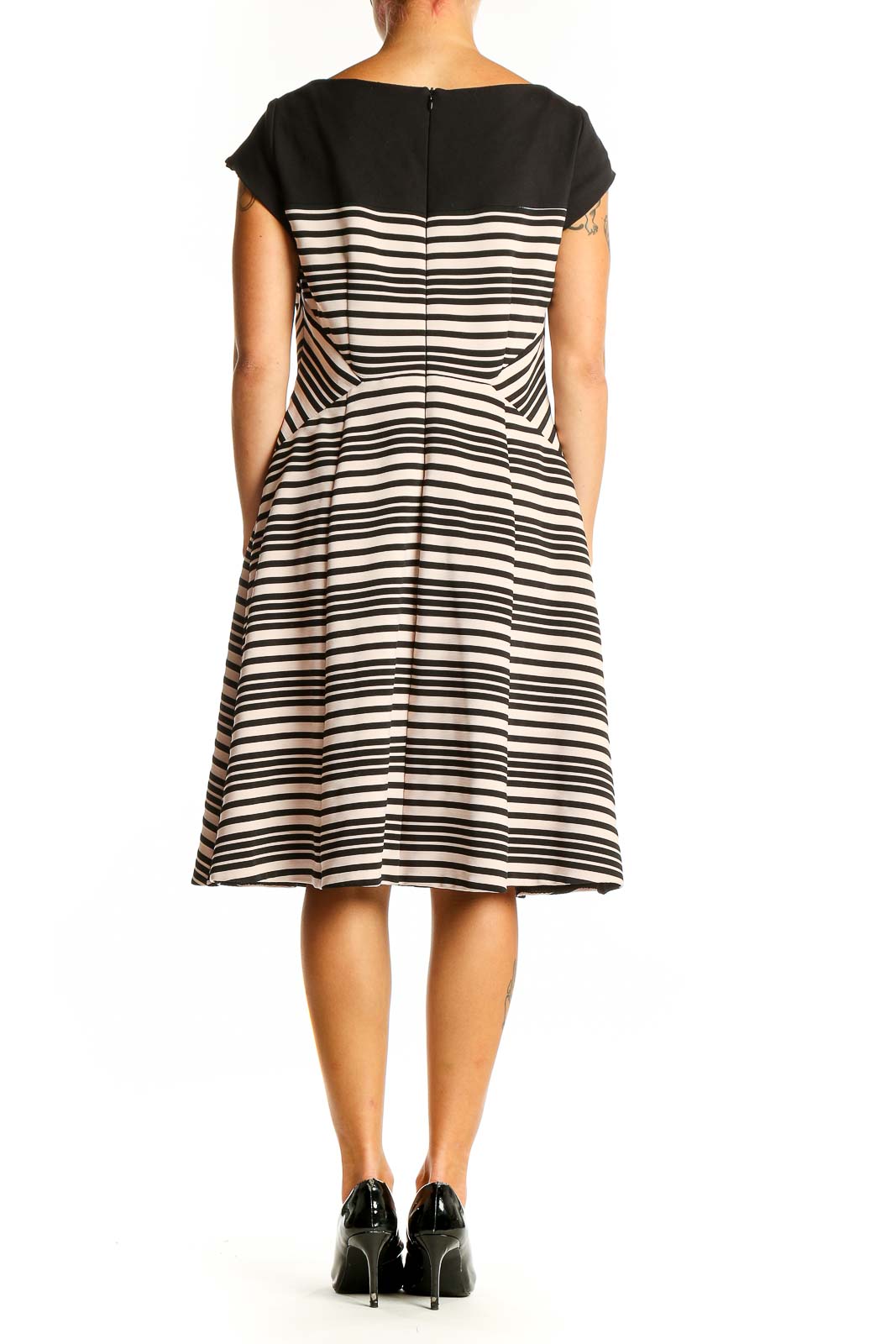 Side view of Nanette Lepore black and white striped fit-and-flare dress showing diagonal waist pattern