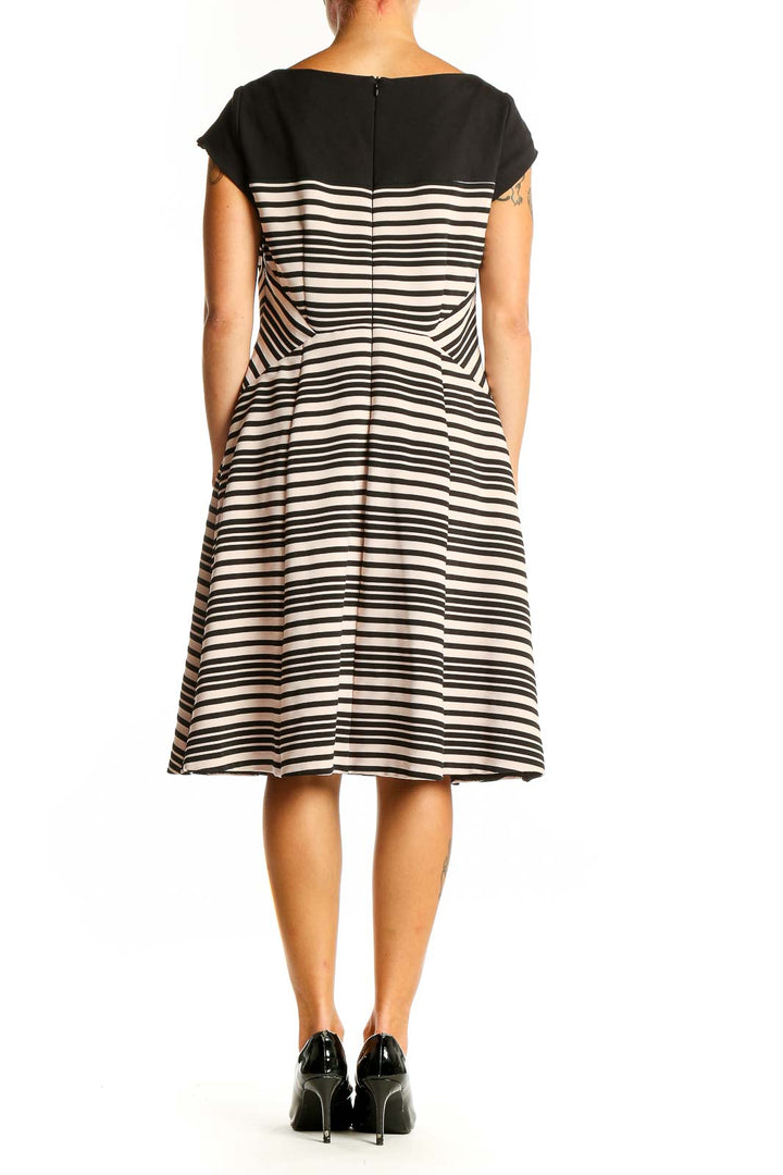 Side view of Nanette Lepore black and white striped fit-and-flare dress showing diagonal waist pattern
