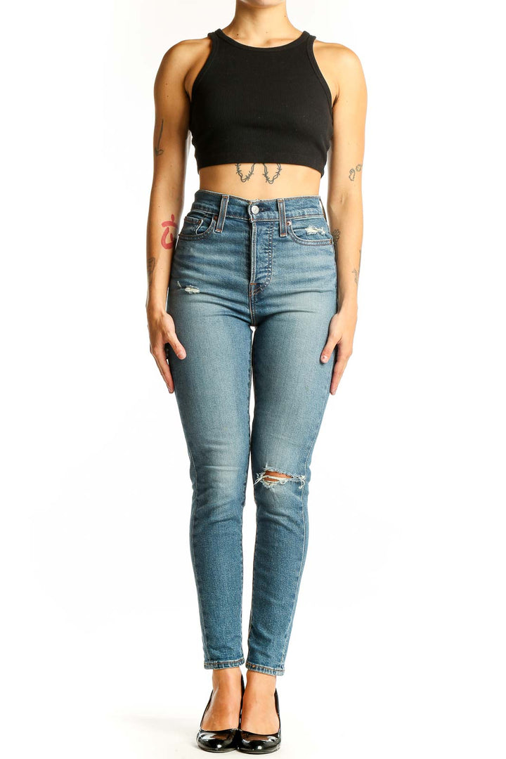 Front view of Levi's light blue high-waist skinny jeans with distressing