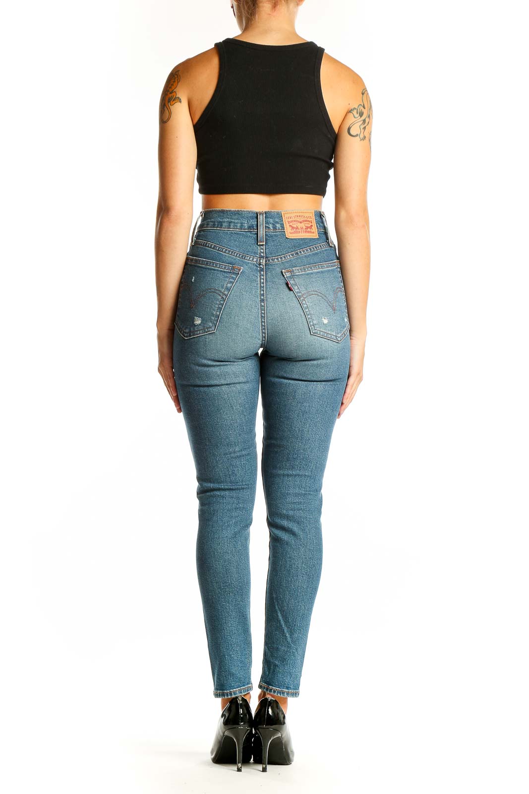 Side view of woman wearing Levi's light blue high-waist skinny jeans