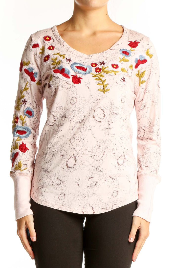 Front view of pink Sundance long sleeve top with colorful floral embroidery