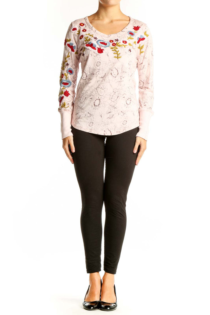 Front view of pink Sundance long sleeve top with colorful floral embroidery