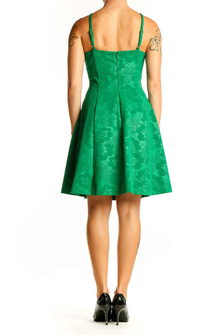 Side view of green Guess dress showing fit-and-flare silhouette and spaghetti straps