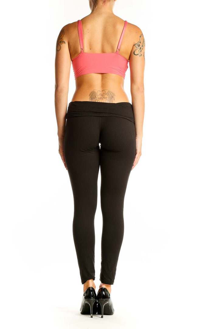 Side view of model wearing coral V-neck crop top with black pants