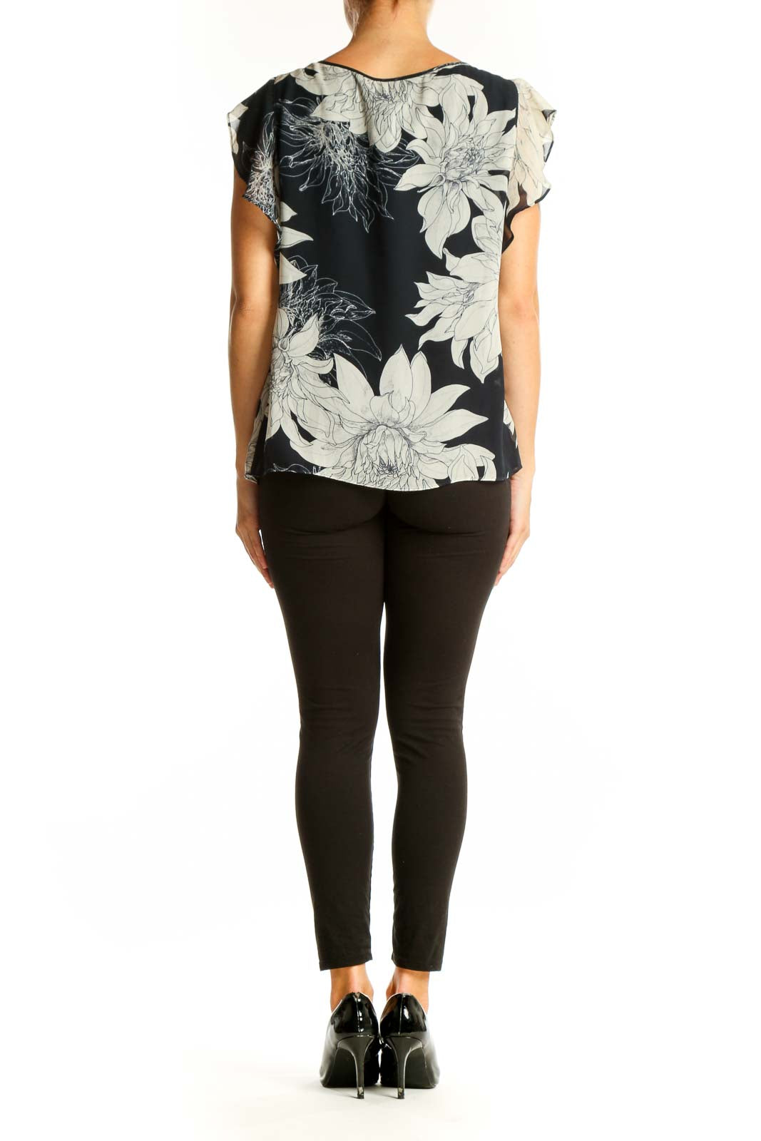 Side view of Vince Camuto black and white floral print blouse showing flutter sleeve detail