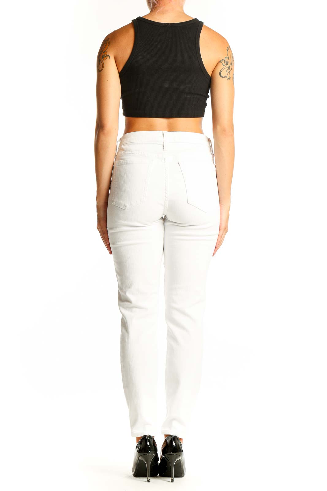 Side view of model wearing white J.Crew denim jeans with black crop top