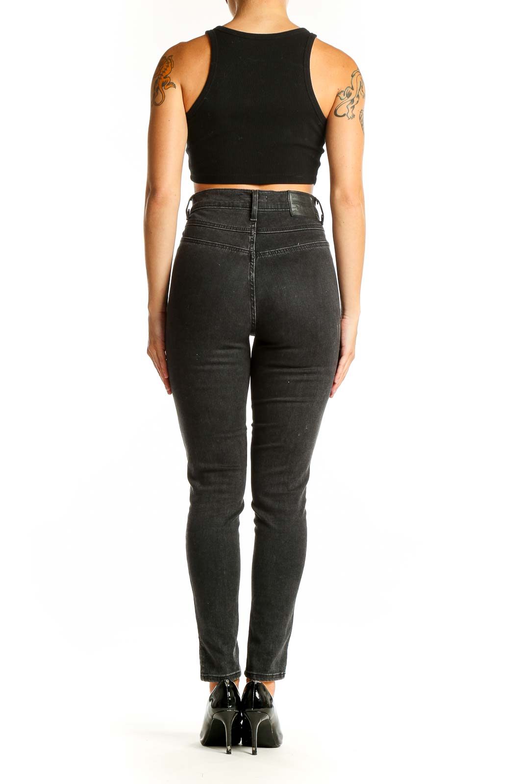 Side view of Levi's black high-waisted skinny jeans on model