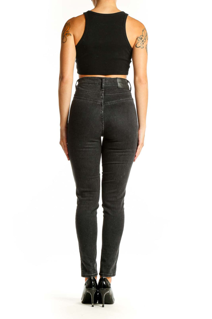 Side view of Levi's black high-waisted skinny jeans on model