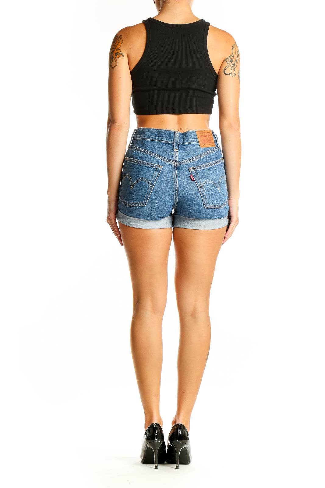 Side view of woman wearing Levi's Premium blue denim high-waisted shorts