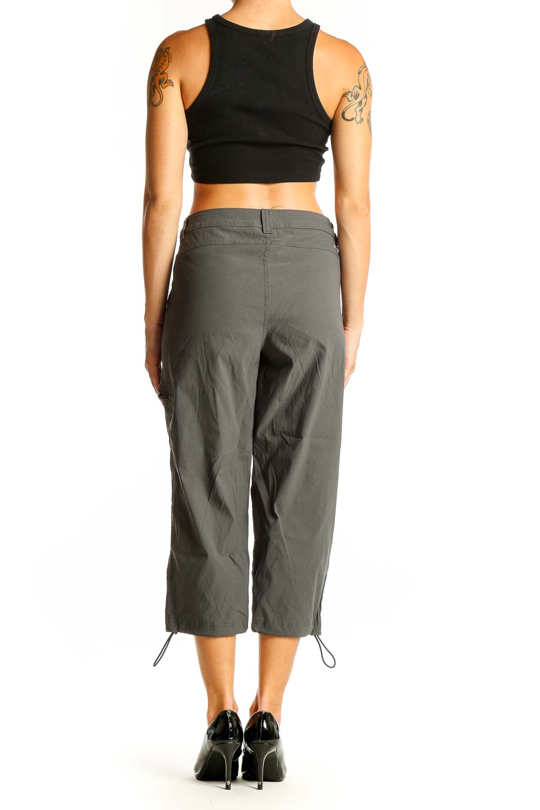 Side view of woman wearing olive green Eddie Bauer capri cargo pants with black top