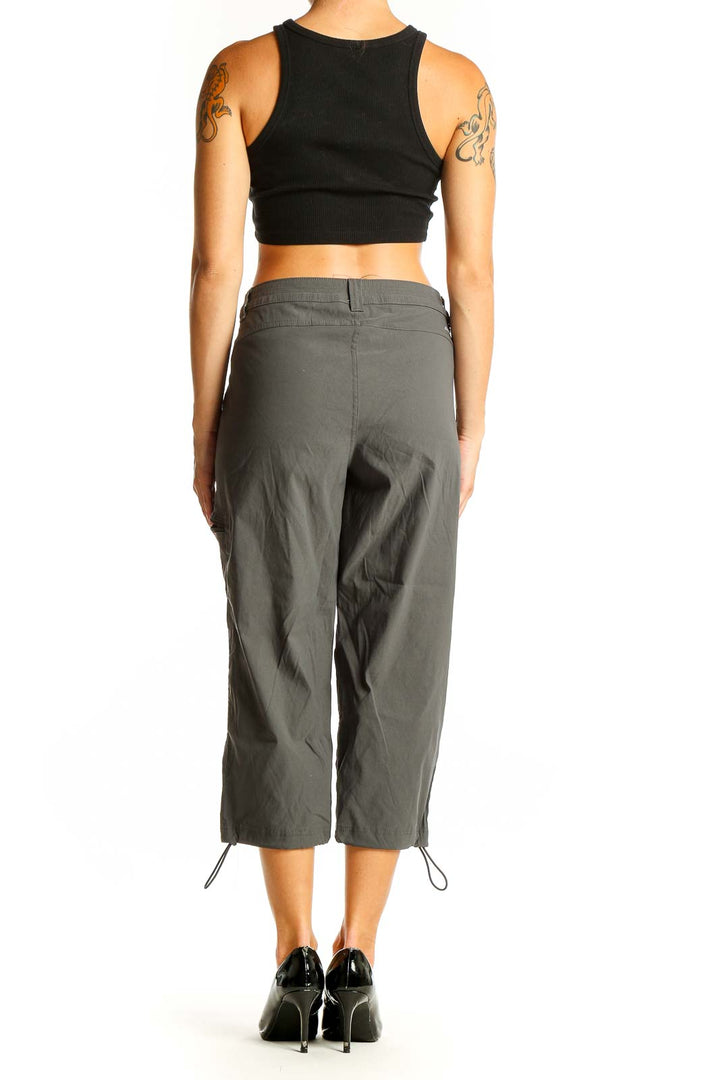 Side view of woman wearing olive green Eddie Bauer capri cargo pants with black top