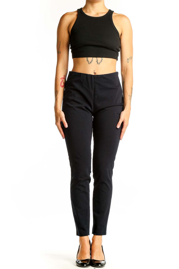 Front view of Uniqlo black ankle-length pants with crop top